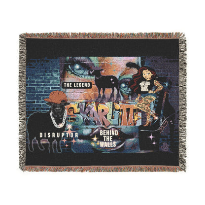 Woven blanket with artistic design featuring animals and text on a black background