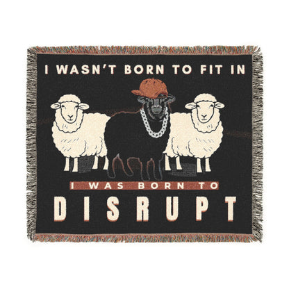 Blanket with graphic of sheep and text 'I wasn't born to fit in, I was born to disrupt' on a black background.