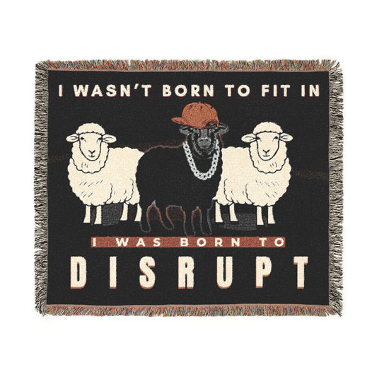 Blanket with graphic of sheep and text 'I wasn't born to fit in, I was born to disrupt' on a black background.
