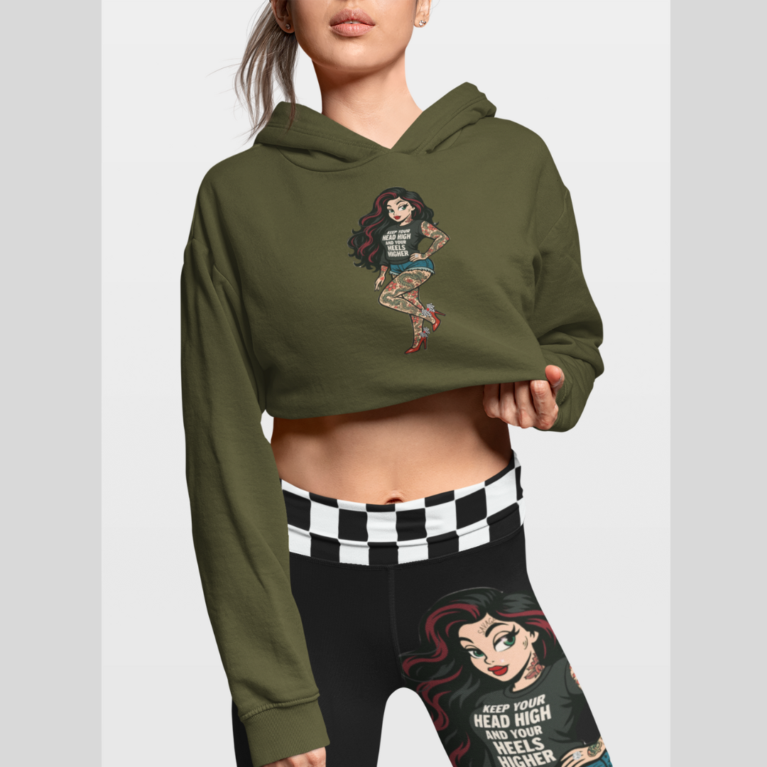 Person wearing a green hoodie and black leggings with graphic designs on a light gray background. The bean Grind Streetwear.